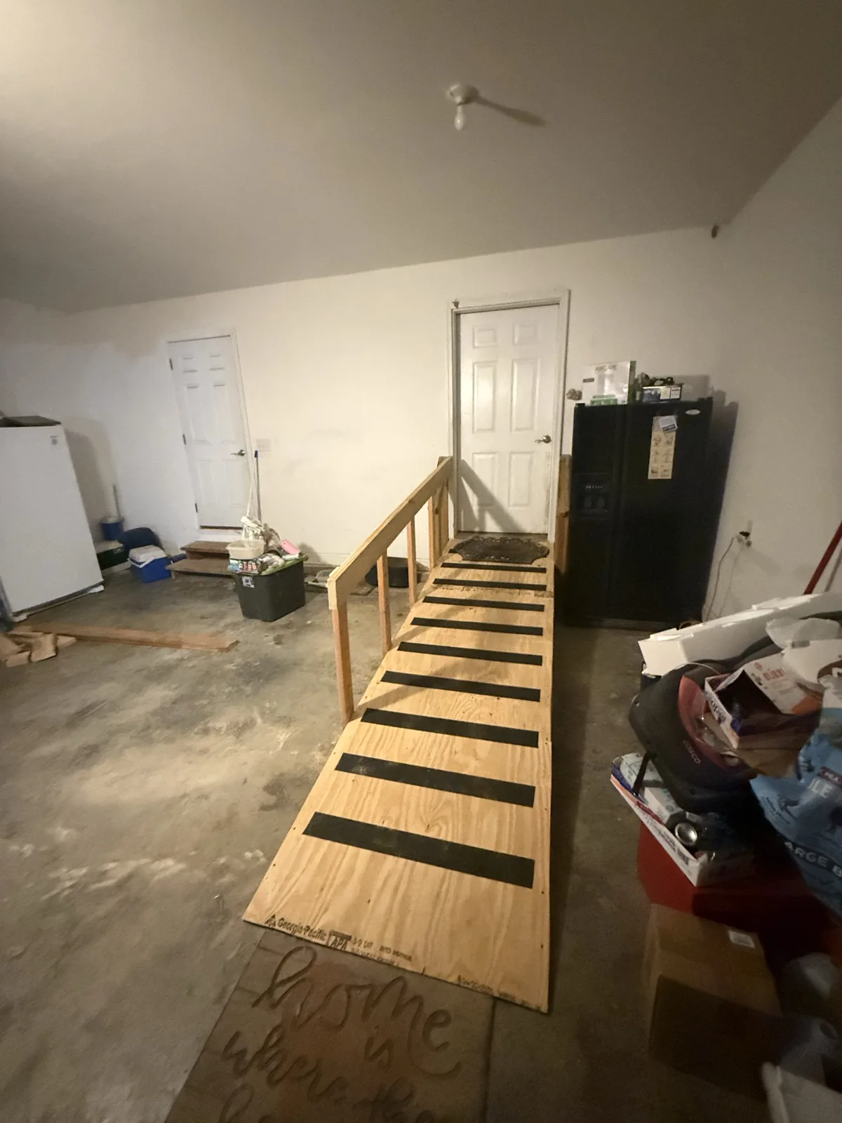 Custom interior access ramp built with handrail and grip strips